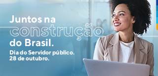 Fundo azul, com a foto de uma mulher negra com camiseta branca e terno bege, de pé, segurando notebook branco. E escrito no banner: Juntos na construção do Brasil. Dia do servidor público. 28 de Outubro.