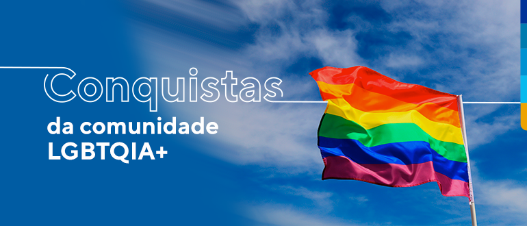 bandeira colorida símbolo da causa lgbtqia+ ao fundo céu azul com nuvens brancas e a frase: conquistas da comunidade lgbtqia+ 