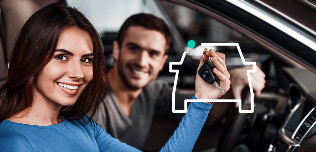 homem e mulher dentro do carro, mulher segurando a chave do carro.