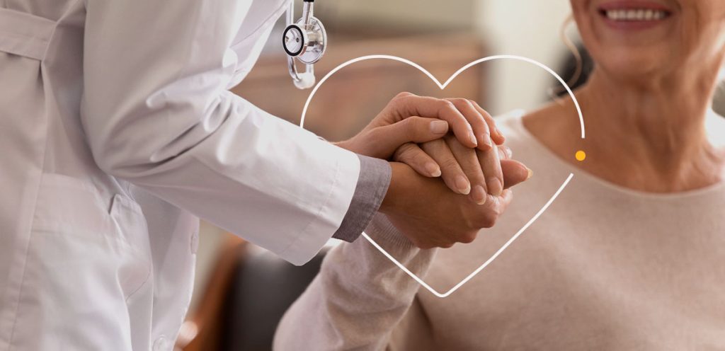 imagem de uma mão médica segurando a mão de um paciente e ao redor a esfera em formato de coração, simbolizando doenças raras no Brasil