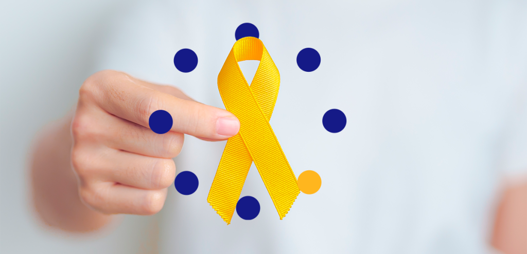 Imagem de uma mão segurando um laço amarelo, simbolizando setembro amarelo.