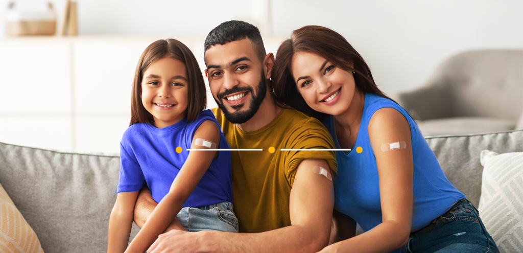 imagem de dois adultos e uma criança com band aid no braço, simbolizando a importância da vacinação para todas as idades